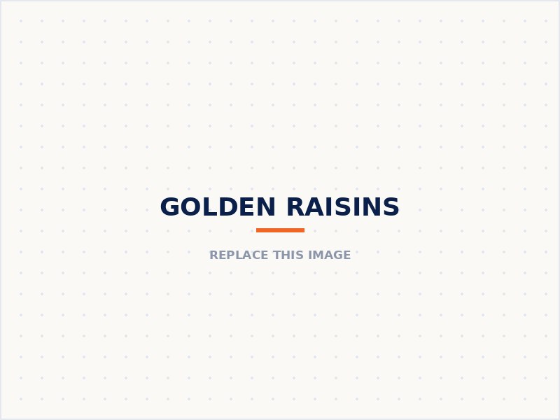 Golden yellow raisins in a bowl with fresh green grapes